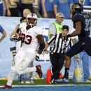 Stanford running back Stepfan Taylor, left, scores on a 49-yard touchdown run with UCLA cornerback Aaron Hester, right, in pursuit during the second quarter of their NCAA college football game, Saturday, Nov. 24, 2012, in Pasadena, Calif. (AP Photo/Alex Gallardo)