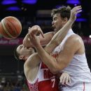 Russia's Vitaliy Fridzon (7) is defended by Spain's Marc Gasol, right, as he tries to shoot during a semifinal men's basketball game at the 2012 Summer Olympics, Friday, Aug. 10, 2012, in London. (AP Photo/Eric Gay)