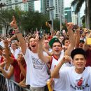 MIAMI, FL - JUNE 25:  Fans cheer as Miami Heat players pass by in a victory parade through the streets during a celebration for the 2012 NBA Champion Miami Heat on June 25, 2012 in Miami, Florida. The Heat beat the Oklahoma Thunder to win the NBA title.  (Photo by Joe Raedle/Getty Images)