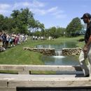 Tiger Woods walks on a bridge to the 15th tee during the Pro-Am at the Memorial golf tournament at the Muirfield Village Golf Club in Dublin, Ohio, Wednesday, May 30, 2012. (AP Photo/Tony Dejak)