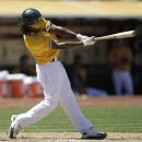 Oakland Athletics' Jemile Weeks swings for an RBI-single off Boston Red Sox's Andrew Miller in the seventh inning of a baseball game on Wednesday, July 4, 2012, in Oakland, Calif. (AP Photo/Ben Margot)