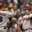 Arizona Diamondbacks' Aaron Hill, right, gets a high-five from teammate Willie Bloomquist after hitting a two-run home run against the Milwaukee Brewers during the fourth inning of a baseball game on Friday, June 29, 2012, in Milwaukee. (AP Photo/Jeffrey Phelps)
