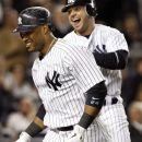 New York Yankees' Nick Swisher, right, celebrates with teammate Robinson Cano after scoring on Cano's fifth-inning two-run home run during their baseball game against the Tampa Bay Rays at Yankee Stadium in New York, Thursday, May 10, 2012. (AP Photo/Kathy Willens)