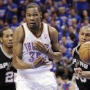 Oklahoma City Thunder forward Kevin Durant (35) passes the ball after splitting San Antonio Spurs defenders Kawhi Leonard (2) and Boris Diaw (33) during the first half of Game 4 in the NBA basketball playoffs Western Conference finals, Saturday, June 2, 2012, in Oklahoma City. (AP Photo/Sue Ogrocki)
