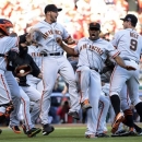 The San Francisco Giants celebrate after they defeated the Cincinnati Reds 6-4 in Game 5 of the National League division baseball series, Thursday, Oct. 11, 2012, in Cincinnati. The Giants won the final three games, all in Cincinnati, and advanced to the NL championship series. (AP Photo/Michael Keating)