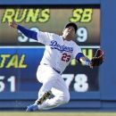 Los Angeles Dodgers  Bobby Abreu  makes a sliding catch to rob Ryan Braun  of Milwaukee Brewers of a hit during a baseball game in Los Angeles Monday, May 28, 2012.(AP Photo/Reed Saxon)