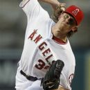 Los Angeles Angels starting pitcher Jered Weaver throws to the Oakland Athletics during the first inning of a baseball game in Anaheim, Calif., Monday, April 16, 2012. (AP Photo/Chris Carlson)
