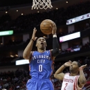Oklahoma City Thunder guard Russell Westbrook (0) drives to the basket past Houston Rockets forward Marcus Morris (2) during the first half of an NBA basketball game, Saturday, Dec. 29, 2012, in Houston. (AP Photo/Bob Levey)