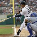 Detroit Tigers' Quintin Berry, left, connects for a two-run triple to deep center during the third inning of a baseball game against the Kansas City Royals in Detroit, Friday, July 6, 2012. (AP Photo/Carlos Osorio)