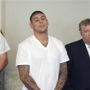 Former New England Patriots tight end Aaron Hernandez, left, stands with his attorney Michael Fee, right, during arraignment in Attleboro District Court Wednesday, June 26, in Attleboro, Mass. Hernandez was charged with murdering Odin Lloyd, a 27-year-old semi-pro football player for the Boston Bandits, whose body was found June 17 in an industrial park in North Attleborough, Mass. (AP Photo/The Sun Chronicle, Mike George, Pool)