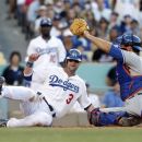 Los Angeles Dodgers Adam Kennedy is tagged out at home by New York Mets catcher Mike Nickeas in the sixth inning of a baseball game in Los Angeles on Sunday, July 1, 2012. (AP Photo/Christine Cotter)