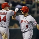 Los Angeles Angels' Albert Pujols (5) celebrates his solo home run with teammate Mark Trumbo (44) against the Oakland Athletics during the seventh inning of a baseball game on Monday, April 29, 2013 in Oakland. Calif. (AP Photo/Marcio Jose Sanchez)