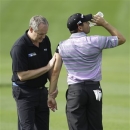 Spain's Sergio Garcia receives medical treatment on the 1st hole during the second round of the Dubai Desert Classic Golf tournament in Dubai, United Arab Emirates, Friday, Feb. 1, 2013. (AP Photo/Kamran Jebreili)