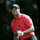 Tiger Woods watching his tee shot off the third hole during the final round of play in the Tour Championship golf tournament at East Lake Golf Club, in Atlanta, Sunday, Sept. 22, 2013. (AP Photo/John Bazemore)
