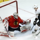 Chicago Blackhawks goalie Corey Crawford (50) makes a save on a rebound attempt by Anaheim Ducks right wing Corey Perry during the second period of an NHL hockey game, Tuesday, Feb. 12, 2013, in Chicago. (AP Photo/Charlie Arbogast)