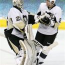 Pittsburgh Penguins goalie Marc-Andre Fleury (29) is congratulated by teammate defenseman Matt Niskanen (2) after the overtime shootout ending the NHL hockey game against the Dallas Stars in Dallas, Wednesday, Feb. 29, 2012. The Penquins won 4-3 in overtime. (AP Photo/LM Otero)