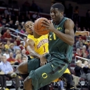 Oregon's Damyean Dotson is defended by Southern California's Jio Fontan (1) during the first half of an NCAA college basketball game in Los Angeles, Thursday, Jan. 17, 2013. (AP Photo/Jae C. Hong)