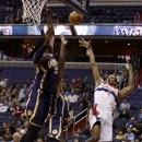 Washington Wizards forward Trevor Ariza shoots over Indiana Pacers center Roy Hibbert, left, and forward Paul George in the first half of an NBA basketball game Monday, Nov. 19, 2012, in Washington. (AP Photo/Alex Brandon)