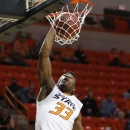 Oklahoma State guard Marcus Smart dunks against Emporia State in the first half of an NCAA college exhibition basketball game in Stillwater, Okla., Friday, Nov. 1, 2013. (AP Photo/Sue Ogrocki)