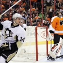 Pittsburgh Penguins' Chris Kunitz reacts after scoring on Philadelphia Flyers goalie Ilya Bryzgalov, rear, in the first period of an NHL hockey game, Thursday, March 7, 2013, in Philadelphia. Kunitz went on to score again in the third period of the Penguins' 5-4 win. (AP Photo/Tom Mihalek)