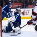 Toronto Maple Leafs goaltender James Reimer makes a save on New Jersey Devils left winger Steve Sullivan, right, during the first period of their NHL hockey game in Toronto, Monday, April 15, 2013. (AP Photo/The Canadian Press, Frank Gunn)