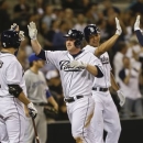 San Diego Padres' Jedd Gyorko, center, high-fives with Carlos Quentin and Jason Marquis as Will Venable high-fives with Yonder Alonso, right, in the fifth inning of a baseball game against the Tornoto Blue Jays in San Diego, Friday, May 31, 2013. Gyorko had doubled in two runs and then a throwing error allowed Gyorko to score.  (AP Photo/Lenny Ignelzi)