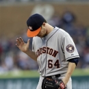Houston Astros starting pitcher Lucas Harrell reacts after giving up a one-run double to Detroit Tigers' Ramon Santiago during the fifth inning of a baseball game in Detroit, Tuesday, May 14, 2013. (AP Photo/Carlos Osorio)