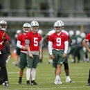 New York Jets quarterback Geno Smith (7) throws as quarterbacks Matt Simms (5), Bryce Petty (9), and Ryan Fitzpatrick (14) look on during an NFL football organized team activity, Wednesday, May 20, 2015, in Florham Park, N.J. (AP Photo/Julio Cortez)