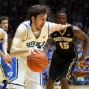 Duke's Ryan Kelly drives past Wake Forest's Amaud William Adala Moto (45) and Travis McKie, right, during the first half of an NCAA college basketball game in Durham, N.C., Saturday, Jan. 5, 2013. (AP Photo/Ted Richardson)