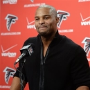 Free-agent defensive end Osi Umenyiora speaks to reporters in Flowery Branch, Ga., after signing a a two-year deal with the NFL football Atlanta Falcons, Thursday, March 28, 2013. (AP Photo/Atlanta Journal-Constitution, Johnny Crawford)