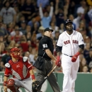 Boston Red Sox's David Ortiz, right, watches his two-run home run beside home plate umpire Marvin Hudson, center, and Los Angeles Angels catcher Hank Conger, left, in the sixth inning of the second game of a baseball doubleheader in Boston, Saturday, June 8, 2013. (AP Photo/Michael Dwyer)