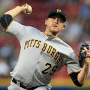 Pittsburgh Pirates starting pitcher Kevin Correia throws against the Cincinnati Reds in the second inning of a baseball game, Tuesday, Sept. 11, 2012, in Cincinnati. (AP Photo/Al Behrman)