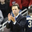 FILE - In this Dec. 19, 2012 file photo, Florida International coach Richard Pitino applauds his team's effort during the second half of an NCAA college basketball game against Louisville in Louisville, Ky. Minnesota is in advanced discussions with Richard Pitino, the son of Louisville coach Rick Pitino, to take over for Tubby Smith. Two people with knowledge of the discussions say Pitino engaged in negotiations with Minnesota officials on Wednesday, April 3, 2013. The people requested anonymity because the deal has not been formally completed. In his lone season at Florida International, Pitino led the Panthers to an 18-14 record, the school's first winning season in 13 years. (AP Photo/Timothy D. Easley, File)