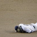 New York Yankees shortstop Derek Jeter lays on the infield after injuring himself in the 12th inning of Game 1 of the American League championship series against the Detroit Tigers Sunday, Oct. 14, 2012, in New York. (AP Photo/Charlie Riedel)
