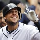 Seattle Mariners' Alex Liddi smiles and points skyward after hitting a grand slam against the Texas Rangers in the fifth inning of a baseball game on Wednesday, May 23, 2012, in Seattle. (AP Photo/Elaine Thompson)