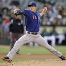 Texas Rangers' Derek Holland works against the Oakland Athletics in the first inning of a baseball game, Tuesday, June 5, 2012, in Oakland, Calif. (AP Photo/Ben Margot)