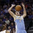 Denver Nuggets forward Danilo Gallinari (8) loses control of the ball after a foul by Oklahoma City Thunder guard Russell Westbrook (0) in the first quarter of an NBA basketball preseason game in Oklahoma City, Sunday, Oct. 21, 2012. (AP Photo/Sue Ogrocki)