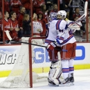 New York Rangers goalie Henrik Lundqvist (30), from Sweden, celebrates with defenseman Steve Eminger (44) after Game 7 first-round NHL Stanley Cup playoff hockey series against the Washington Capitals, Monday, May 13, 2013 in Washington. The Rangers won 5-0. (AP Photo/Alex Brandon)