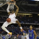 Florida's Will Yeguete dunks against Florida Gulf Coast during the second half of a regional semifinal game in the NCAA college basketball tournament, Saturday, March 30, 2013, in Arlington, Texas. (AP Photo/Tony Gutierrez)