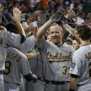 Oakland Athletics' Brandon Moss (37) is congratulated in the dugout after hitting a three-run home run against the Detroit Tigers in the eighth inning of a baseball game in Detroit, Wednesday, Aug. 28, 2013. (AP Photo/Paul Sancya)