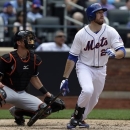 Miami Marlins catcher Jeff Mathis, left, watches as New York Mets' Ike Davis flies out in the sixth inning of a Mets 8-4 loss in a baseball game in New York, Sunday, June 9, 2013. (AP Photo/Kathy Willens)