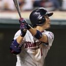 Minnesota Twins' Tsuyoshi Nishioka hits a sacrifice fly off Cleveland Indians' Chris Perez in the ninth inning of a baseball game, Tuesday, Aug. 7, 2012, in Cleveland. Justin Morneau scored. The Twins won 7-5. (AP Photo/Tony Dejak)