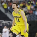 Michigan guard Nik Stauskas reacts after making a 3-point shot against Florida during the first half of a regional final game in the NCAA college basketball tournament, Sunday, March 31, 2013, in Arlington, Texas. (AP Photo/David J. Phillip)