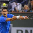 Novak Djokovic, of Serbia, returns a shot to John Isner during their match at the BNP Paribas Open tennis tournament, Wednesday, March 18, 2015, in Indian Wells, Calif. Djokovic won 6-4, 7-6 (5). (AP Photo/Mark J. Terrill)