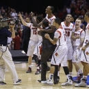 Louisville players celebrate following their 85-63 win over Duke in the Midwest Regional final in the NCAA college basketball tournament, Sunday, March 31, 2013, in Indianapolis. (AP Photo/Darron Cummings)