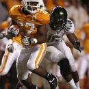 FILE - This Sept. 11, 2010 file photo shows Tennessee running back David Oku (27) carrying the ball as he's hit by Oregon linebacker Michael Clay (46) during an NCAA football game at Neyland Stadium in Knoxville, Tenn. Oku has signed with Arkansas State. ASU coach Gus Malzahn announced the signing of the former standout from Midwest City, Okla., on Wednesday, June 27, 2012. (AP Photo/Wade Payne, File)