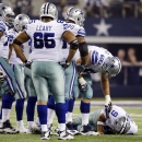 ADDS COWBOYS PLAYER IDENTIFICATION - Dallas Cowboys' Doug Free checks on quarterback Tony Romo (9) after he went down injured against the New York Giants during the first half of an NFL football game Sunday, Sept. 8, 2013, in Arlington, Texas. (AP Photo/Tony Gutierrez)