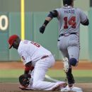 Atlanta Braves' Martin Prado, right, is put out at first base by Philadelphia Phillies first baseman Ryan Howard on a double play in the first inning of a baseball game, Friday, July 6, 2012, in Philadelphia. (AP Photo/Laurence Kesterson)