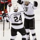 Los Angeles Kings' Colin Fraser (24) and Brad Richardson celebrate after Fraser scored against the New Jersey Devils during the first period of Game 1 of the NHL hockey Stanley Cup finals Wednesday, May 30, 2012, in Newark, N.J. (AP Photo/Kathy Willens)