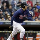 Minnesota Twins' Joe Mauer hits a single off Los Angeles Angels pitcher Jason Vargas in the first inning of a baseball game, Tuesday, April 16, 2013, in Minneapolis. (AP Photo/Jim Mone)